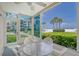 Sunroom with ocean view and seating area at 6144 Midnight Pass Rd # 2N, Sarasota, FL 34242