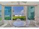 Bright sunroom with table and chairs, offering stunning ocean views at 6144 Midnight Pass Rd # 2N, Sarasota, FL 34242