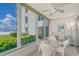 Sunroom with ocean view and seating area at 6144 Midnight Pass Rd # 2N, Sarasota, FL 34242
