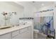 Modern bathroom with double sinks, white cabinets, and shower at 6404 Silverstar Dr, Sarasota, FL 34240