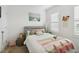 Cozy bedroom with gray platform bed and white bedding at 6404 Silverstar Dr, Sarasota, FL 34240