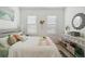 Bright bedroom with gray platform bed, white bedding, and window shutters at 6404 Silverstar Dr, Sarasota, FL 34240