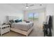 Bedroom with large bed, TV, and water view at 6404 Silverstar Dr, Sarasota, FL 34240