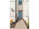 Front entrance with teal door and brick walkway at 6404 Silverstar Dr, Sarasota, FL 34240