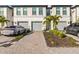 Front view of townhouses with grey garages and paved driveways at 6404 Silverstar Dr, Sarasota, FL 34240