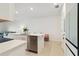 Open concept kitchen with island, stainless steel appliances, and white cabinets at 6404 Silverstar Dr, Sarasota, FL 34240