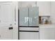 Modern kitchen features a sleek refrigerator and white cabinetry at 6404 Silverstar Dr, Sarasota, FL 34240
