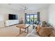 Living room with large TV, comfy seating, and lake views at 6404 Silverstar Dr, Sarasota, FL 34240