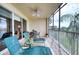 Spacious screened balcony with outdoor furniture and lake view at 6450 Watercrest Way # 303, Lakewood Ranch, FL 34202