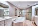 Elegant bathroom featuring a soaking tub, glass shower, and double vanity at 6450 Watercrest Way # 303, Lakewood Ranch, FL 34202