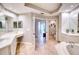 Spacious bathroom with double sinks, a large tub, and separate shower at 6450 Watercrest Way # 303, Lakewood Ranch, FL 34202