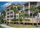 Building exterior with palm trees and golf cart at 6450 Watercrest Way # 303, Lakewood Ranch, FL 34202