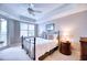 Bright bedroom with iron bed frame and plantation shutters at 6450 Watercrest Way # 303, Lakewood Ranch, FL 34202