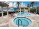 Community pool and spa with lounge chairs at 6450 Watercrest Way # 303, Lakewood Ranch, FL 34202
