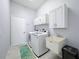 Bright laundry room with washer, dryer, and utility sink at 7011 74Th Street E Cir, Bradenton, FL 34203