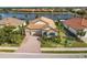 Home with lake view, tile roof, and lush landscaping at 7014 Whittlebury Trl, Lakewood Ranch, FL 34202