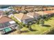Aerial view of community, showcasing lakefront homes and lush landscaping at 7014 Whittlebury Trl, Lakewood Ranch, FL 34202
