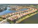 Aerial view of upscale community with lake and numerous homes at 7014 Whittlebury Trl, Lakewood Ranch, FL 34202
