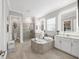 Luxurious bathroom with double vanity, soaking tub, and walk-in shower at 7014 Whittlebury Trl, Lakewood Ranch, FL 34202