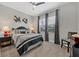 Bright bedroom featuring a queen-size bed and window at 7014 Whittlebury Trl, Lakewood Ranch, FL 34202