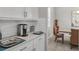 Bright breakfast nook with white cabinets and view into dining area at 7014 Whittlebury Trl, Lakewood Ranch, FL 34202