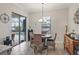 Casual dining area with table and chairs, and view of the pool at 7014 Whittlebury Trl, Lakewood Ranch, FL 34202