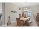 Bright dining room with a farmhouse table and bench seating at 7014 Whittlebury Trl, Lakewood Ranch, FL 34202