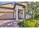 Front entry with stone accents and a two-car garage at 7014 Whittlebury Trl, Lakewood Ranch, FL 34202