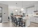 Modern kitchen with white cabinets, quartz countertops, and an island at 7014 Whittlebury Trl, Lakewood Ranch, FL 34202