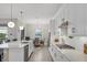 Bright kitchen with white cabinets, quartz countertops and stainless steel appliances at 7014 Whittlebury Trl, Lakewood Ranch, FL 34202