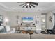 Living area featuring a large TV, comfortable seating and a view of the Primary bedroom at 7014 Whittlebury Trl, Lakewood Ranch, FL 34202