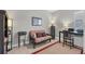 Home office with futon, desk, and built-in shelving at 7014 Whittlebury Trl, Lakewood Ranch, FL 34202
