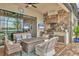Cozy outdoor kitchen with seating and fire pit at 7014 Whittlebury Trl, Lakewood Ranch, FL 34202