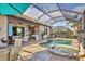 Outdoor kitchen, pool, spa, and seating area at 7014 Whittlebury Trl, Lakewood Ranch, FL 34202