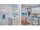 Light blue bathroom with shower/tub combo and white vanity at 716 Blackburn Blvd, North Port, FL 34287