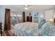 Bedroom with sliding door to patio, dresser, and seashell bedding at 716 Blackburn Blvd, North Port, FL 34287