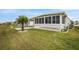 Exterior view of the home, showcasing landscaping and screened porch at 716 Blackburn Blvd, North Port, FL 34287