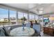 Bright sunroom with canal view, table and chairs at 716 Blackburn Blvd, North Port, FL 34287