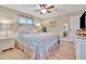 Main bedroom with king bed and light decor at 7167 Wood Creek Dr # 3, Sarasota, FL 34231