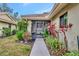 Screened porch entry with walkway and tropical plants at 7167 Wood Creek Dr # 3, Sarasota, FL 34231