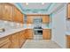 Well-equipped kitchen with light wood cabinets and stainless steel appliances at 7167 Wood Creek Dr # 3, Sarasota, FL 34231