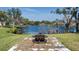 Fire pit overlooking a tranquil lake and lush landscape at 8006 Oak Dr, Palmetto, FL 34221