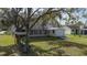 A two-story house with a shed and pergola in the backyard at 8006 Oak Dr, Palmetto, FL 34221