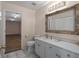 Bathroom with white vanity, ornate mirror and access to extra room at 8006 Oak Dr, Palmetto, FL 34221