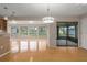 Open concept dining room with hardwood floors and access to a screened porch at 8006 Oak Dr, Palmetto, FL 34221
