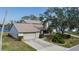 Two-story house with attached garage, landscaping, and a paved driveway at 8006 Oak Dr, Palmetto, FL 34221