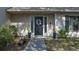 Front door entrance with wreath, planters, and walkway at 8006 Oak Dr, Palmetto, FL 34221