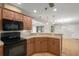 Kitchen with light wood cabinets, black appliances, and granite countertops at 8006 Oak Dr, Palmetto, FL 34221