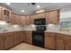 Spacious kitchen with light wood cabinets and black appliances at 8006 Oak Dr, Palmetto, FL 34221