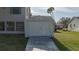 White shed with double doors and a wooden ramp at 8006 Oak Dr, Palmetto, FL 34221